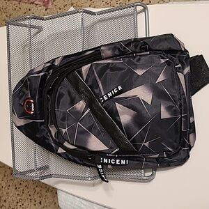 Small Sling Backpack/ Crossbody bag NWOT w/ headphone jack